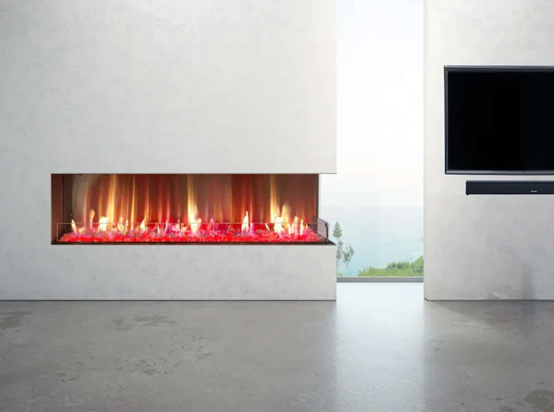 Minimalistic white-walled living area showcasing a sleek, linear fireplace with vibrant red embers, adjacent to an ocean view.