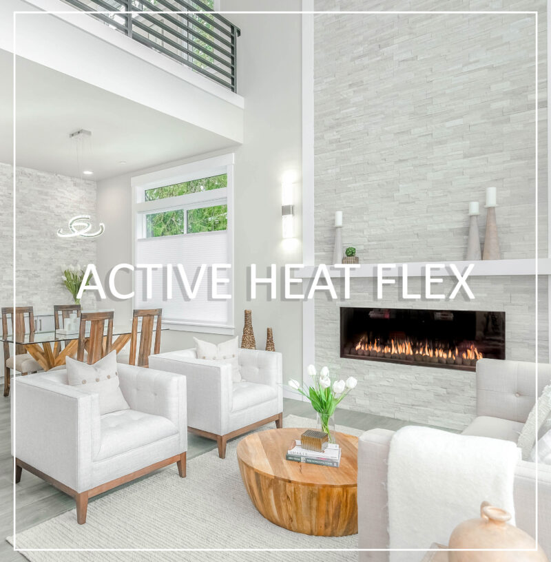 Bright contemporary living space featuring an elegant linear direct vent fireplace built into a white stone wall, highlighting an Active Heat Flex system for efficient heat management.