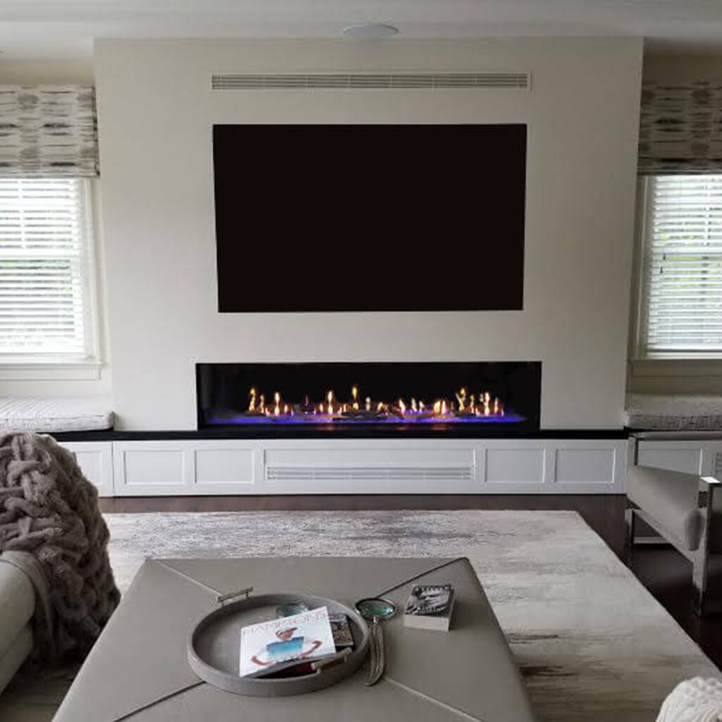 Front Facing 70-inch linear gas fireplace with invisible mesh screen—Free Flow heat release with top vent and low intake, TV above.