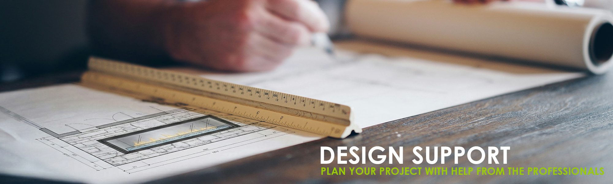 Architectural design support with professional drafting tools, measuring scale, and project planning documents.