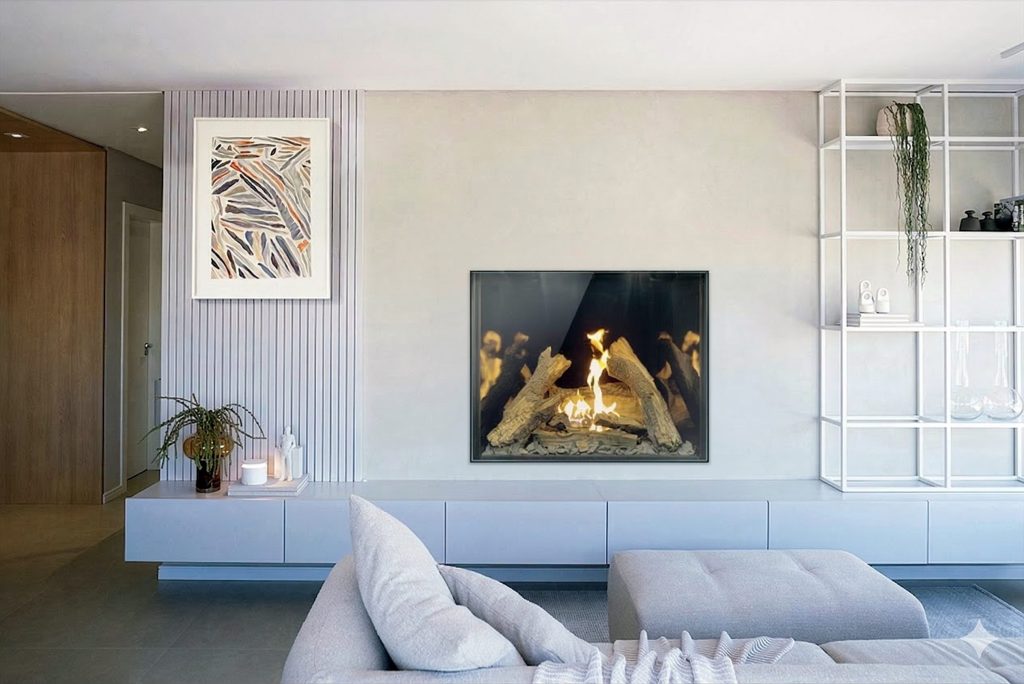 Traditional 42-inch frameless gas fireplace recessed into a light textured wall in a modern living room, featuring Flare’s Bonfire burner with a large oak log set and black embers.