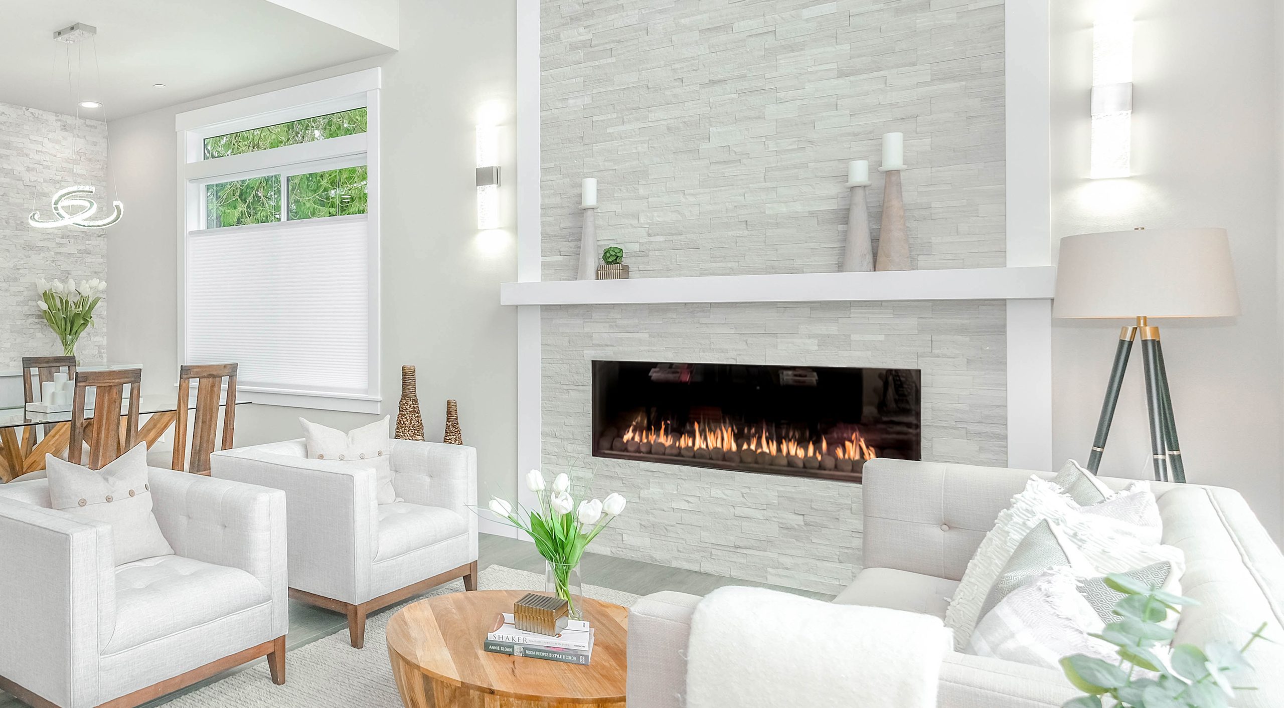 Front Facing 80 R linear direct vent fireplace in a bright modern living room with a white stone feature wall