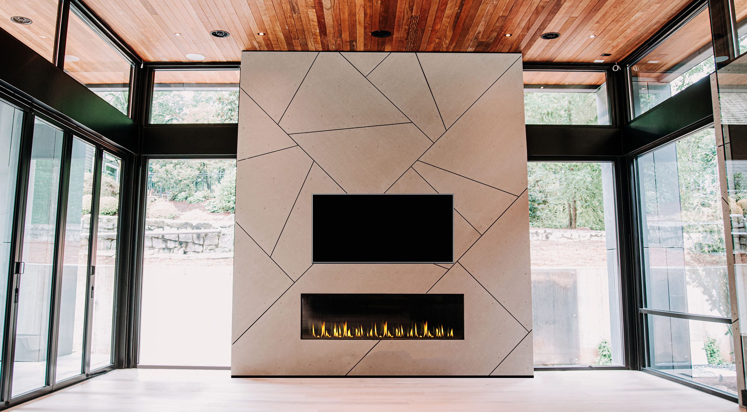 Front Facing 80 R linear direct vent fireplace beneath a TV in a modern floor-to-ceiling feature wall