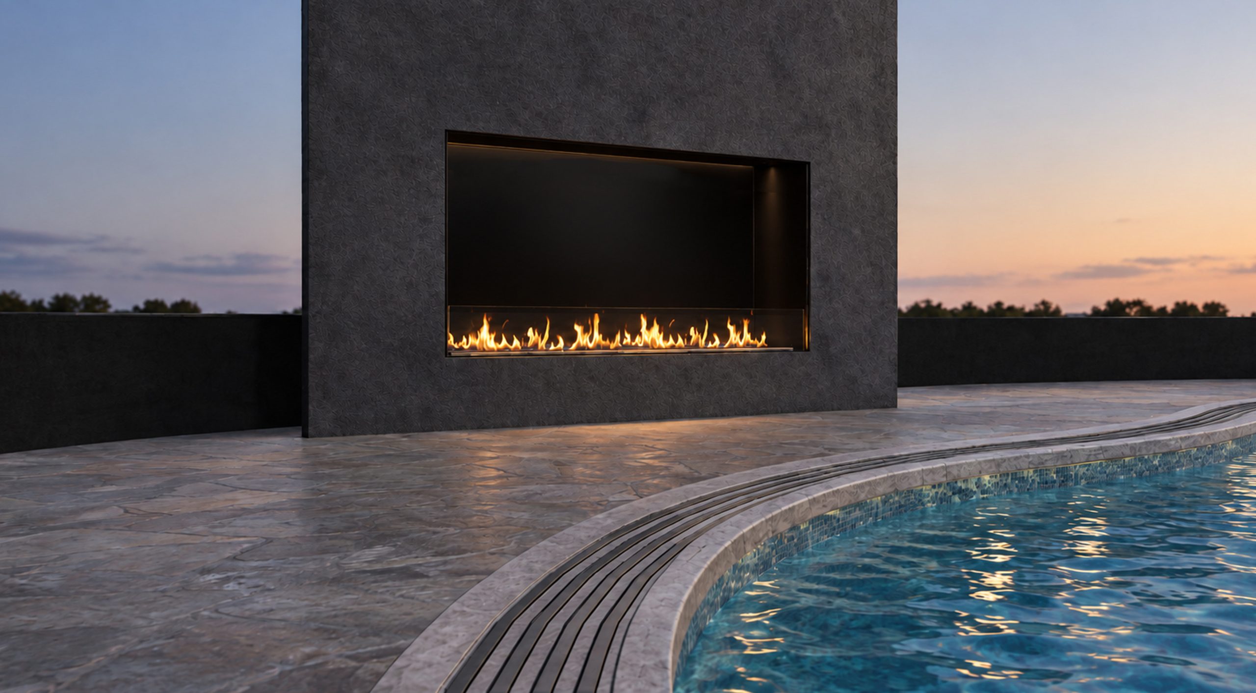 Angled view of the VFF50H linear fireplace beside a curved pool, with stone coping and blue water in the foreground.