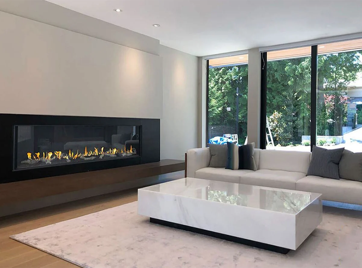 Modern linear gas Flare Front Facing 100" fireplace with 24" high glass in a contemporary living room with a sleek design. FLARE-FF-100-H
